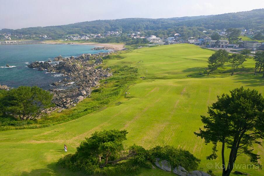 Tanesashi Natural Lawn Area - contrasting green grass and blue waves